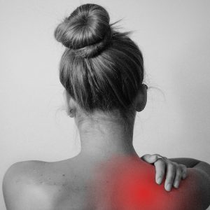 Image of a woman holding her right shoulder, highlighted in red to emphasize pain and discomfort in that area