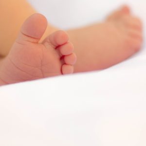 Baby feet on a white sheet